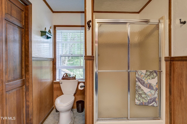 bathroom featuring walk in shower, tile patterned floors, a textured ceiling, toilet, and ornamental molding