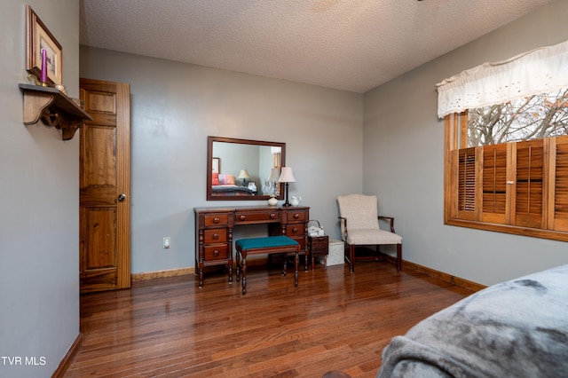 bedroom with a textured ceiling and dark wood-type flooring