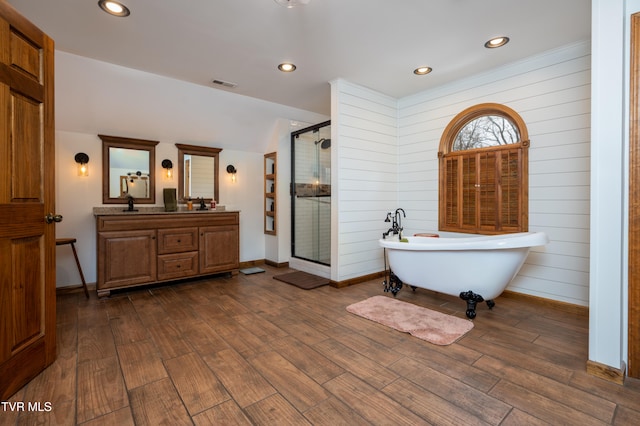 bathroom with separate shower and tub, wooden walls, hardwood / wood-style floors, and vanity