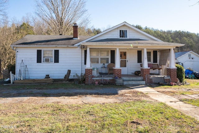 view of front of house with a porch and a front lawn