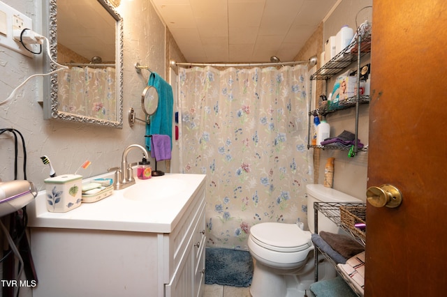 bathroom featuring tile patterned flooring, vanity, and toilet