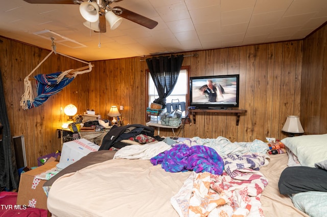 bedroom with wooden walls and ceiling fan