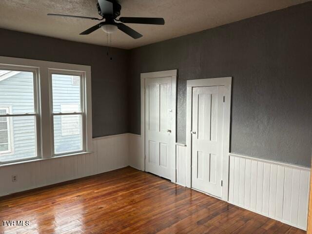 unfurnished bedroom featuring hardwood / wood-style floors and ceiling fan