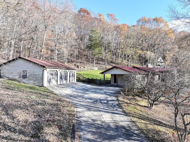 view of front facade with a carport, a front yard, and a garage