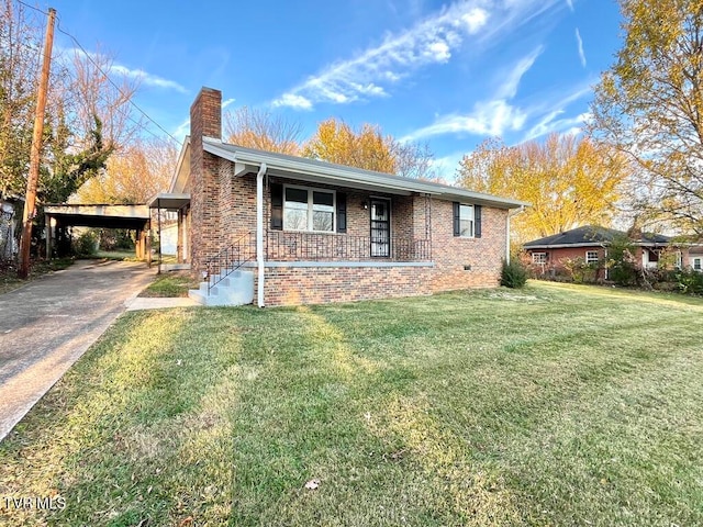 view of front of house with a carport, covered porch, and a front yard