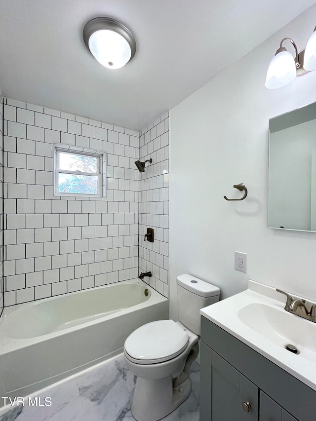 full bathroom featuring vanity, tiled shower / bath combo, and toilet