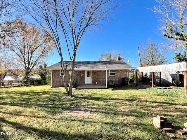 back of property with a lawn