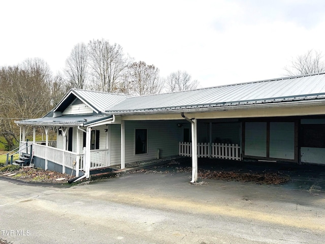 view of side of property with covered porch