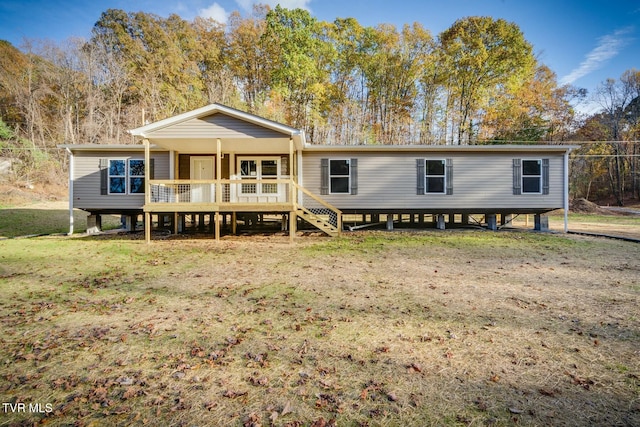 rear view of property with a yard and a deck