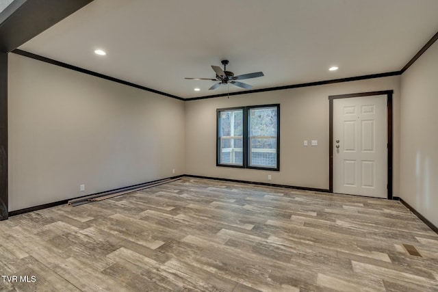 empty room featuring crown molding, light hardwood / wood-style flooring, and ceiling fan