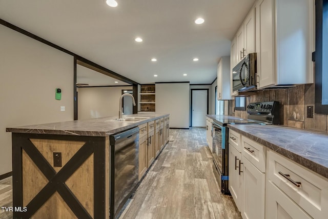 kitchen with sink, black appliances, white cabinets, and a spacious island