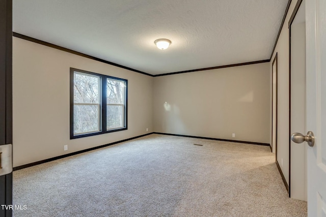 unfurnished bedroom featuring ornamental molding, light colored carpet, and a textured ceiling