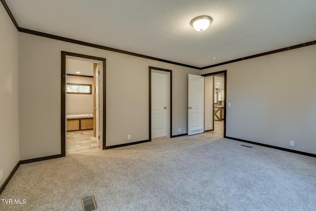 unfurnished bedroom with light carpet, crown molding, and a textured ceiling