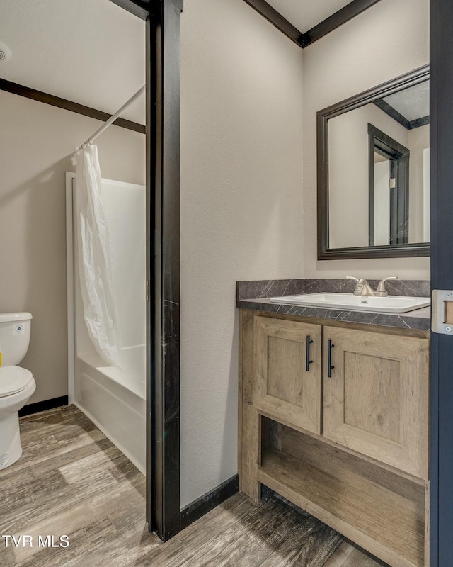 full bathroom featuring vanity, hardwood / wood-style floors, shower / bathtub combination with curtain, and toilet