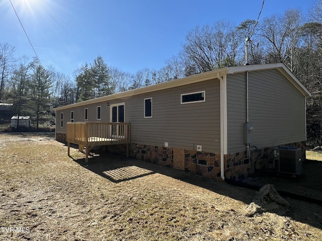 rear view of house featuring a deck and central air condition unit