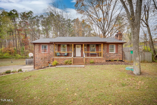 view of front of house with covered porch and a front lawn