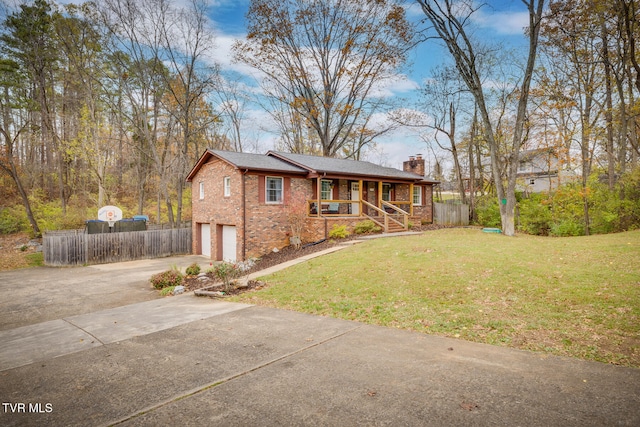 view of front of house with covered porch, a garage, and a front lawn