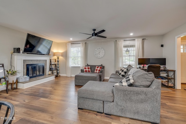 living room with hardwood / wood-style flooring, ceiling fan, and a healthy amount of sunlight