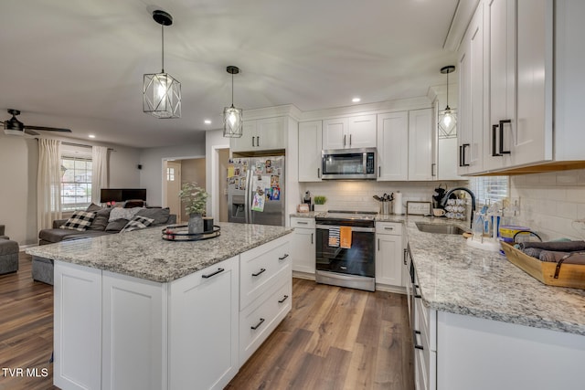 kitchen featuring white cabinets, pendant lighting, sink, and stainless steel appliances