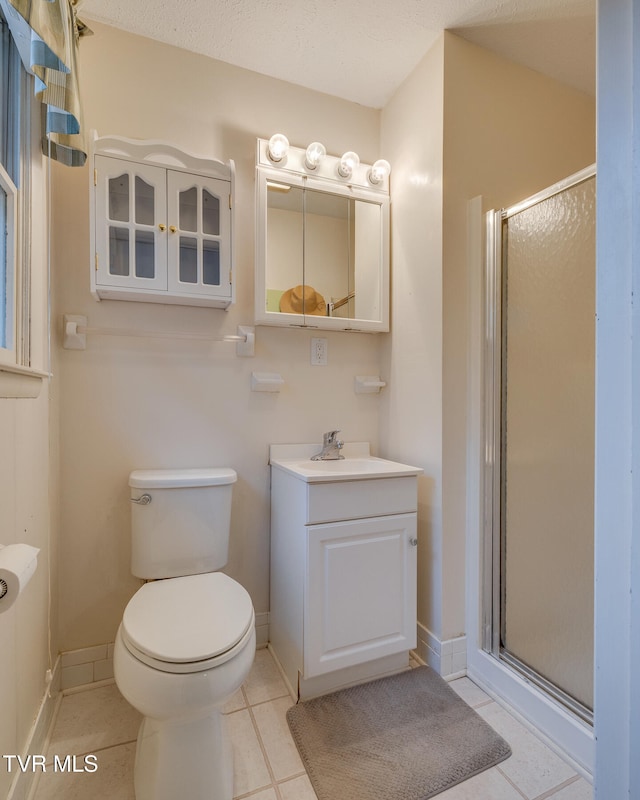 bathroom with walk in shower, tile patterned floors, a textured ceiling, toilet, and vanity