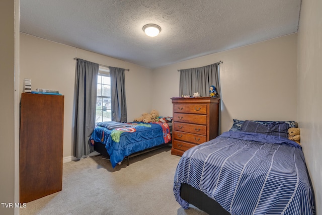 carpeted bedroom featuring a textured ceiling