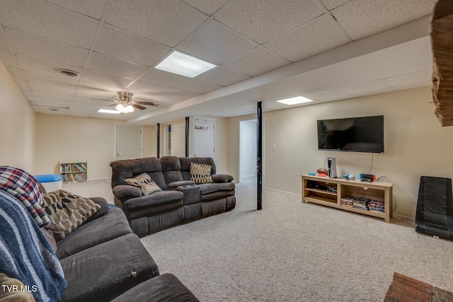 carpeted living room with a paneled ceiling and ceiling fan