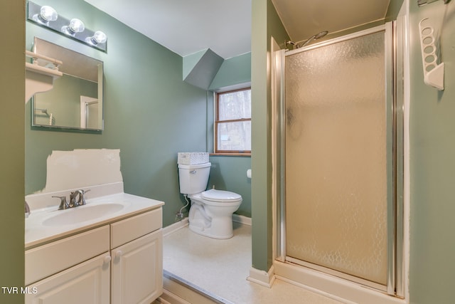 bathroom featuring vanity, an enclosed shower, and toilet