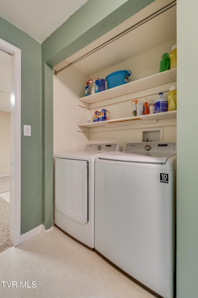 laundry area featuring independent washer and dryer and light colored carpet