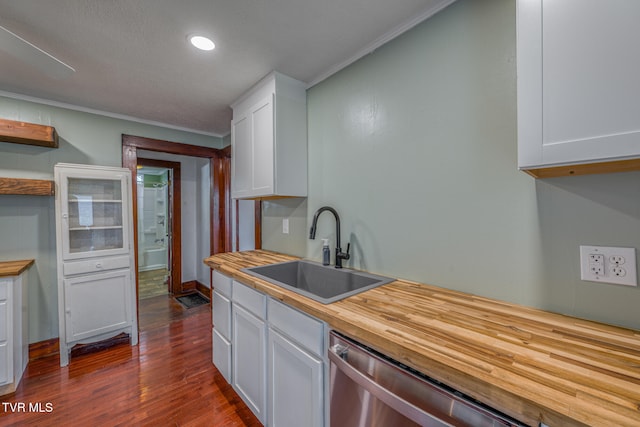 kitchen featuring dark hardwood / wood-style floors, white cabinetry, crown molding, and sink