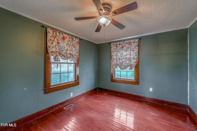 empty room featuring hardwood / wood-style floors, a textured ceiling, and ceiling fan