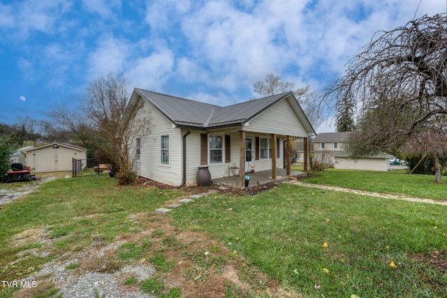 view of front of house featuring a front lawn, a porch, and a storage unit