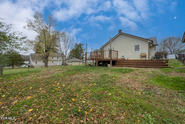 back of house featuring a yard and a deck