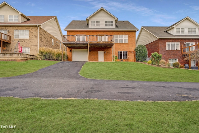 view of front facade with a garage, a front lawn, and a wooden deck