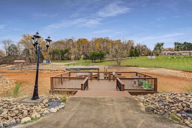 surrounding community with a lawn and a deck