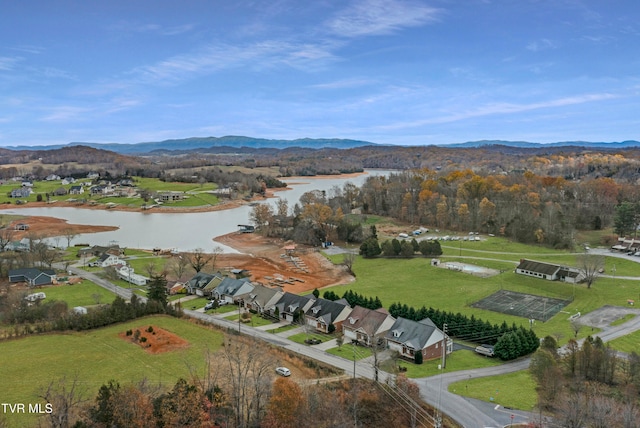 birds eye view of property with a water and mountain view