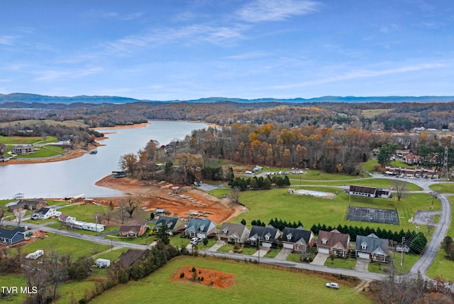 birds eye view of property with a water and mountain view