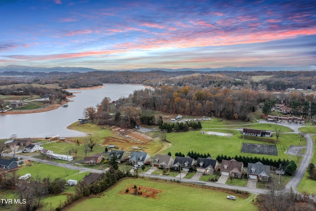 aerial view at dusk with a water view