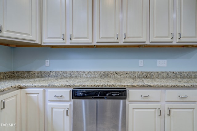 kitchen with stainless steel dishwasher, light stone countertops, and white cabinetry