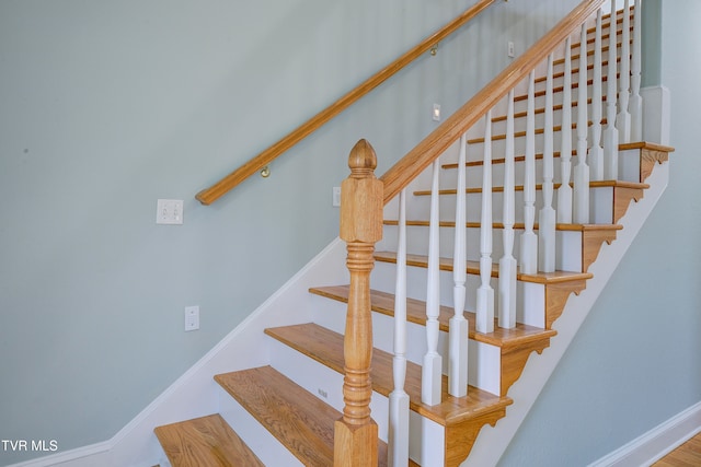 stairs featuring hardwood / wood-style floors