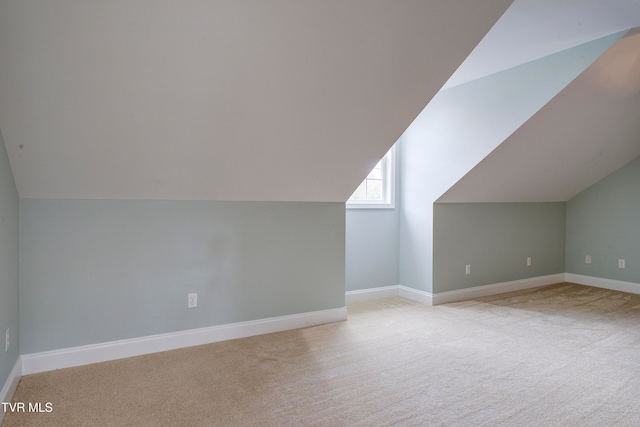 bonus room featuring light colored carpet and lofted ceiling