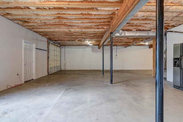 basement with stainless steel fridge with ice dispenser