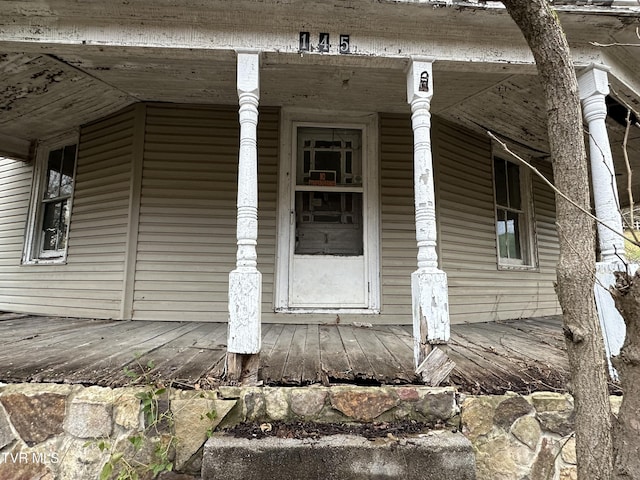 view of exterior entry featuring covered porch