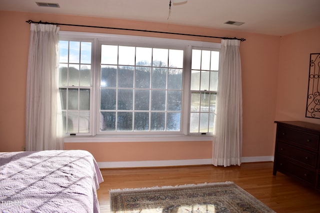 bedroom featuring light hardwood / wood-style floors and multiple windows