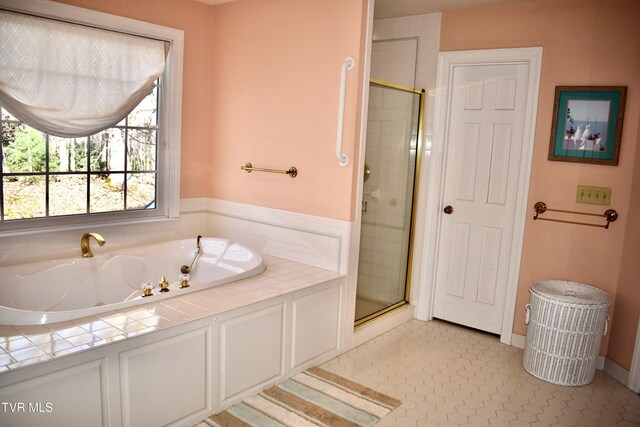 bathroom featuring tile patterned floors and shower with separate bathtub