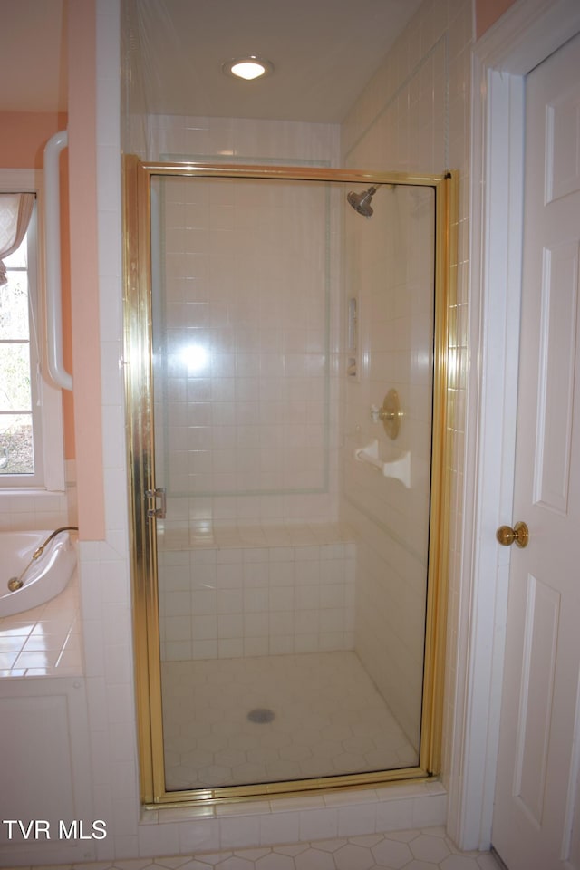 bathroom with tile patterned floors and a shower with door