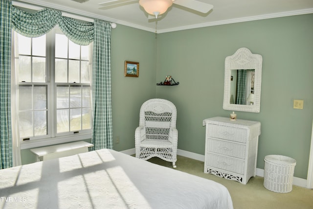 carpeted bedroom with ceiling fan and ornamental molding