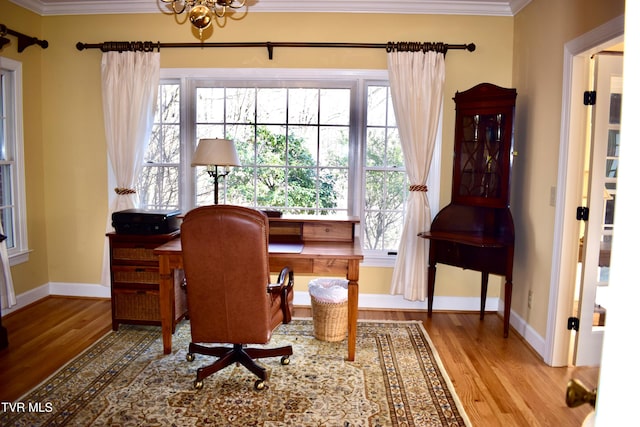 home office with a chandelier, light hardwood / wood-style flooring, and ornamental molding