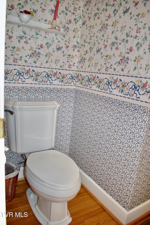 bathroom featuring hardwood / wood-style flooring and toilet