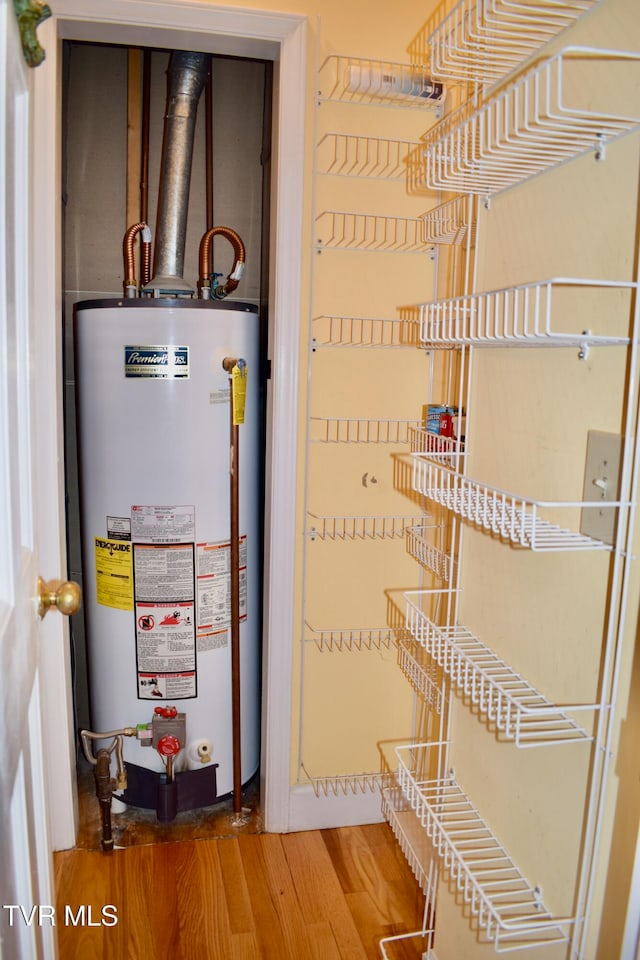 utility room featuring water heater