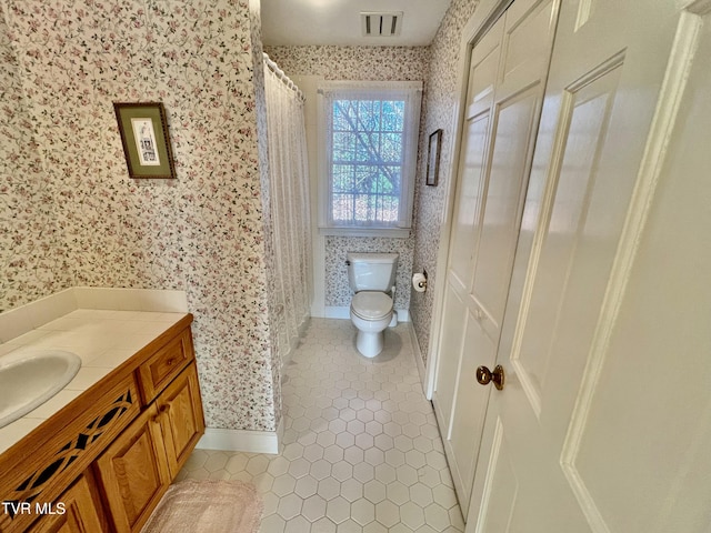 bathroom with tile patterned floors, vanity, and toilet